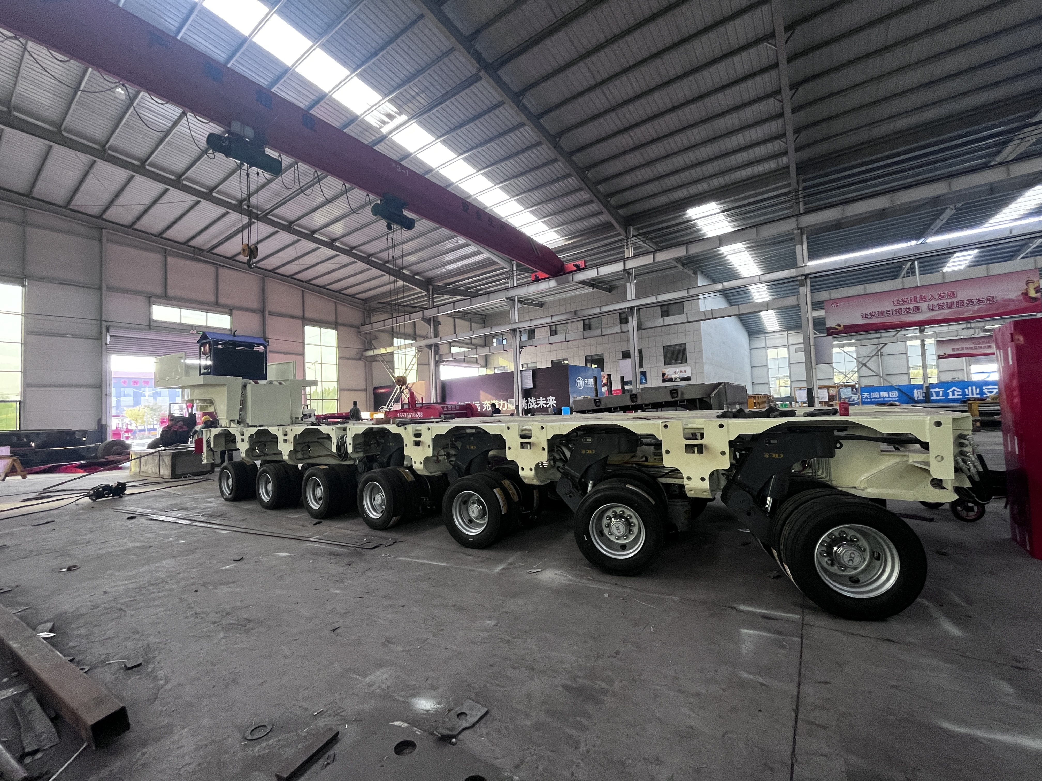 Hydraulic modular trailer (SPMT) under production in factory, multi-axle heavy haul transport vehicle for wind turbine and heavy equipment transport