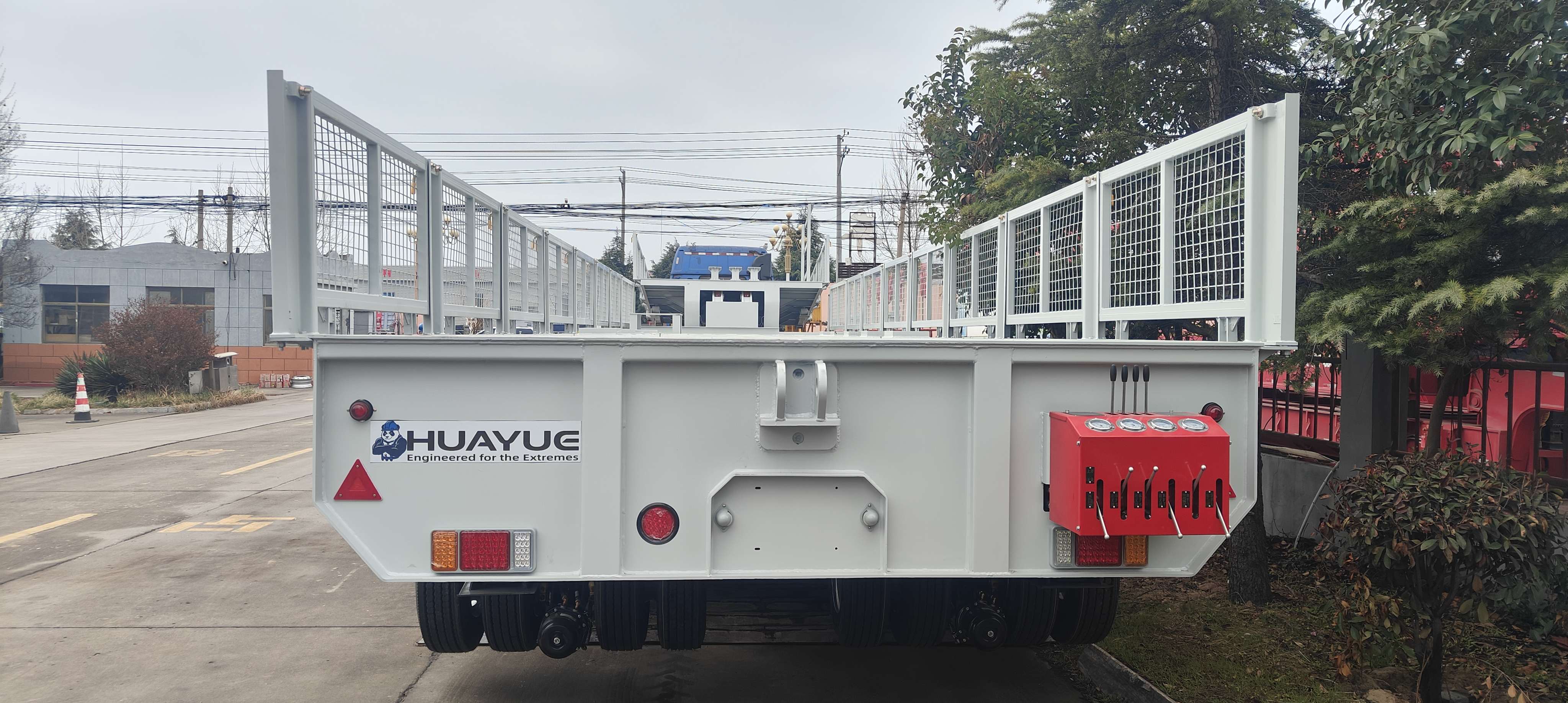 Rear view of the mobile substation transport trailer, highlighting the HUAYUE logo, protective fencing, and the detailed hydraulic control panel