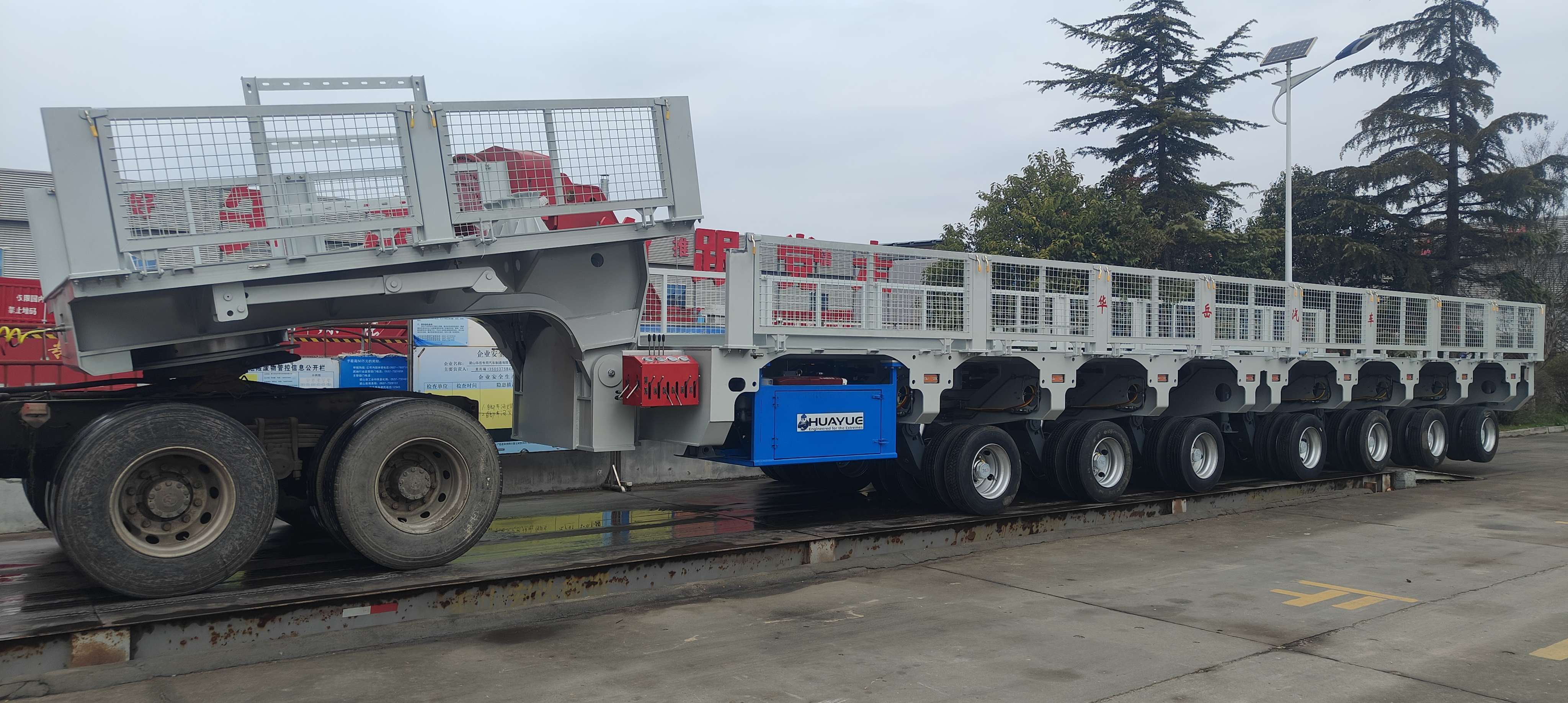 Heavy-duty multi-axle mobile substation trailer designed by HUAYUE, featuring a low deck and hydraulic suspension for maximum stability