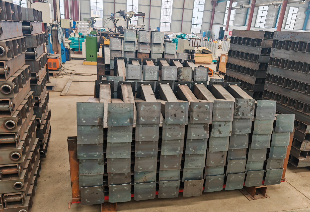 Neatly stacked prefabricated steel outriggers in the HUAYUE workshop, demonstrating the batch production efficiency that enables rapid trailer delivery