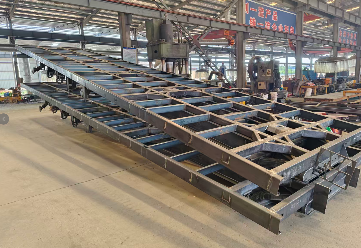 A completed high-yield steel main beam framework for a heavy transport trailer, ready for the next assembly stage at the HUAYUE manufacturing plant.