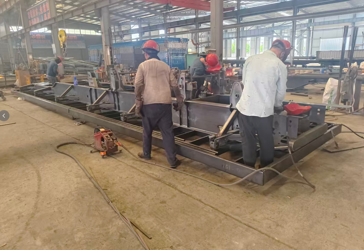 HUAYUE skilled welders assembling a robust heavy-duty trailer chassis, utilizing advanced welding techniques to ensure maximum structural integrity for Middle East export.