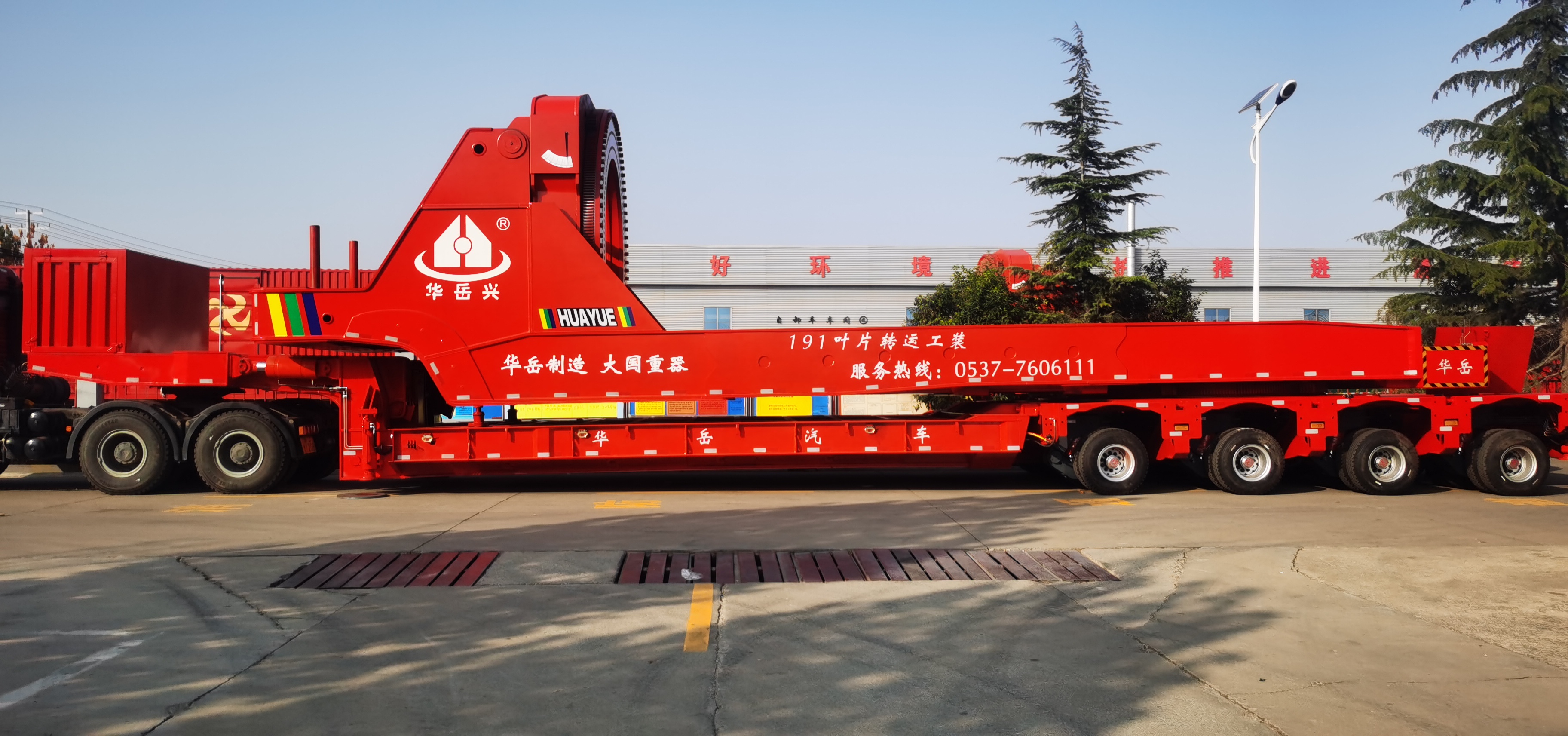 HUAYUE hydraulic wind blade lifter integrated with a modular trailer/SPMT for wind farm transit, showing the complete logistics solution for transporting ultra-long blades through tight areas.