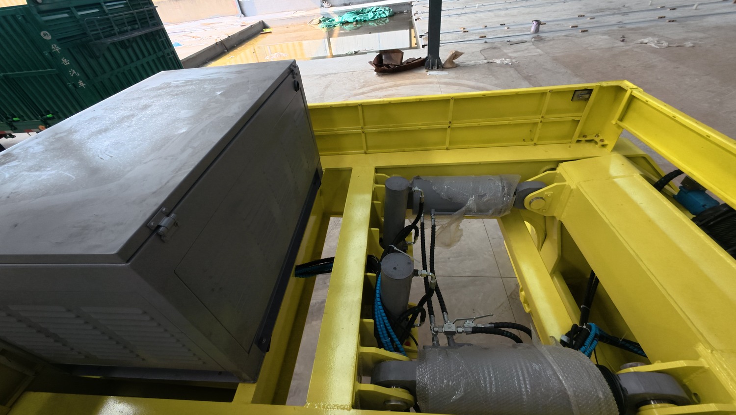 Close view of modular yellow trailer deck sections and connection hardware