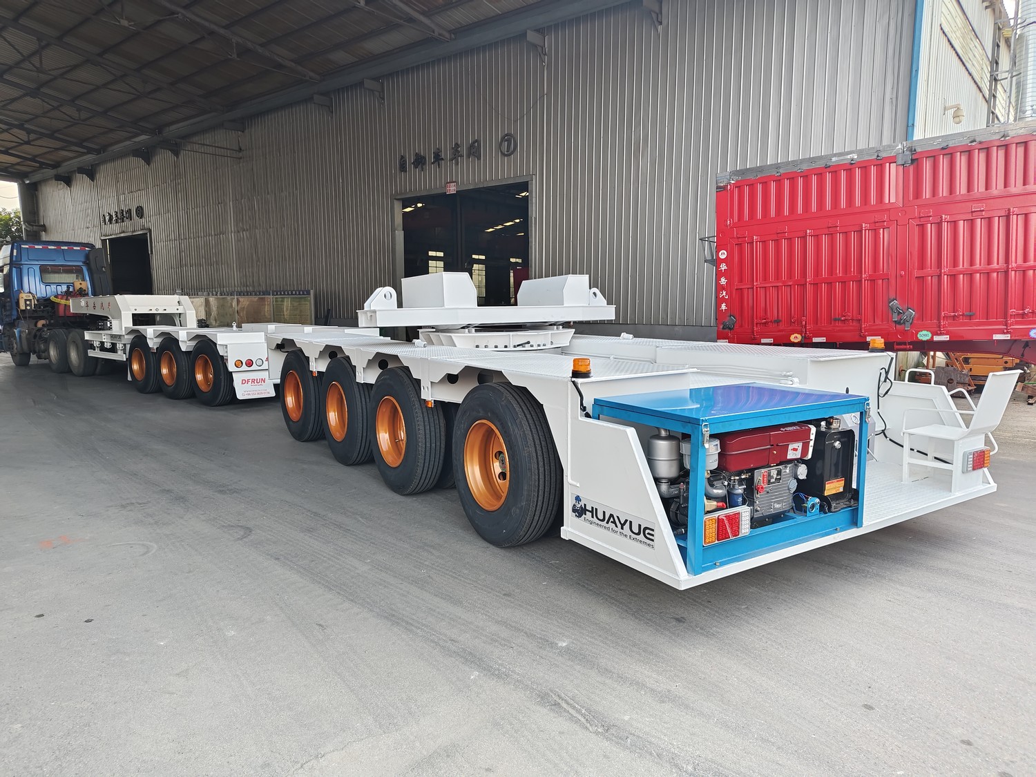 Huayue two-unit bridge transport trailer set photographed at the factory with the 3-axle and 4-axle units visible