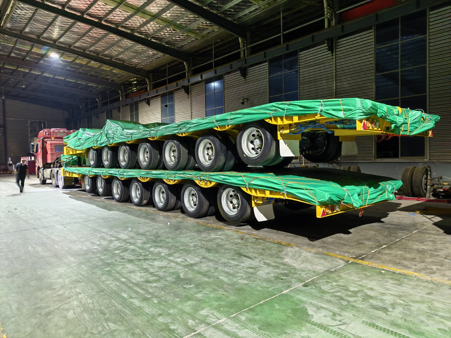 Two covered confidential trailer units inside the factory before export dispatch