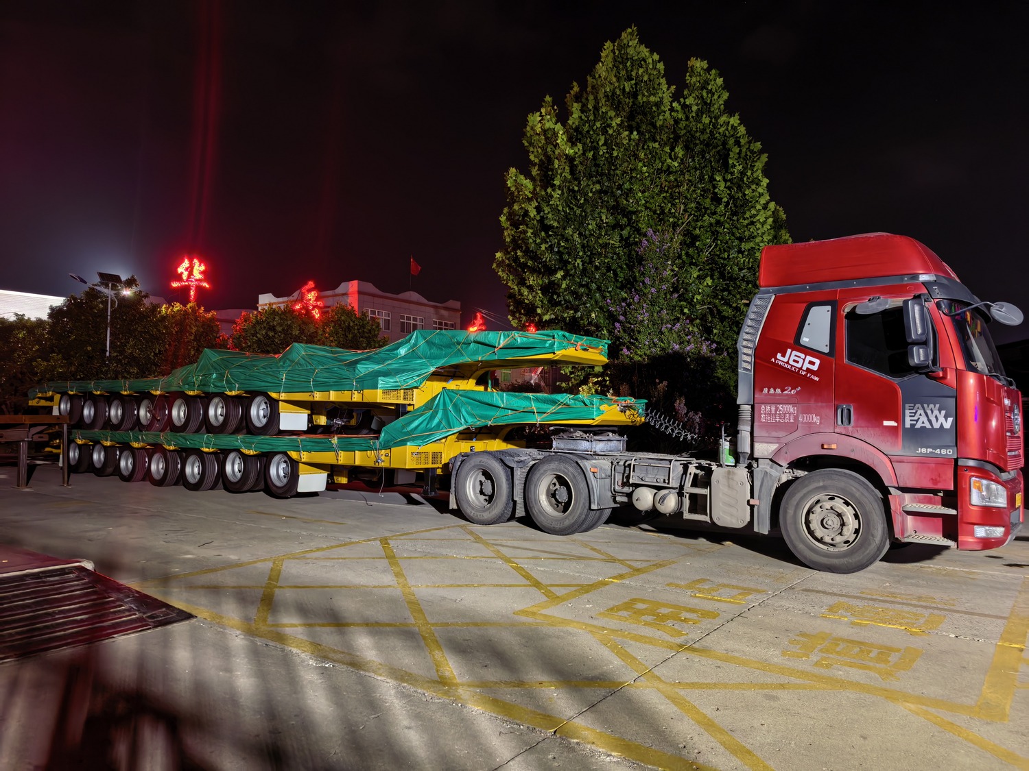 Covered confidential trailer units leaving the factory at night for export dispatch