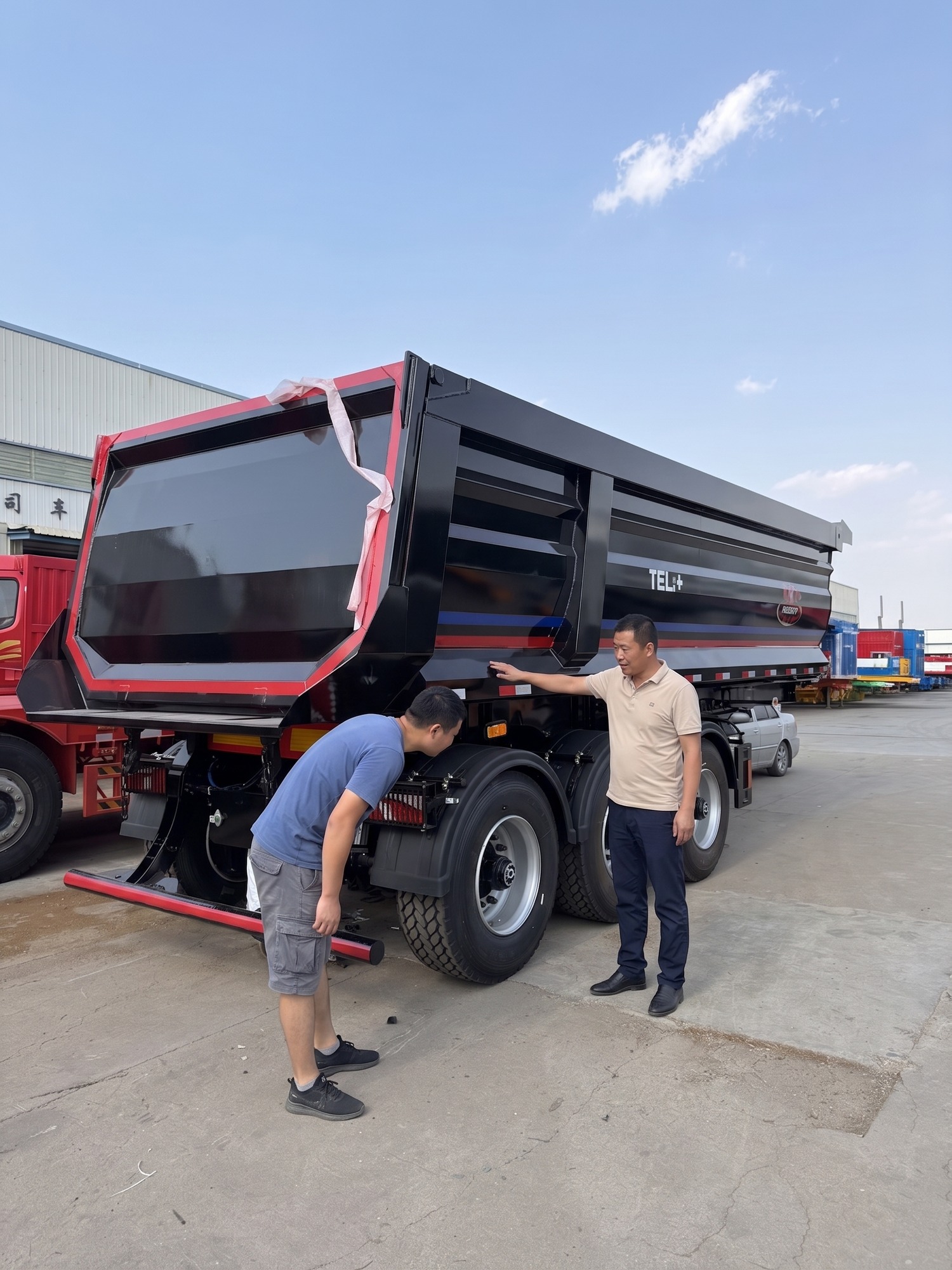 Illustration of a rear-dump trailer configuration discussion in a factory yard
